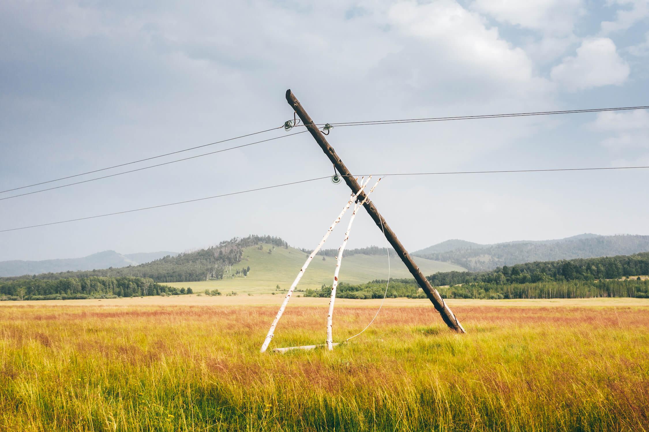 Utility Pole Being propped up after it has failed