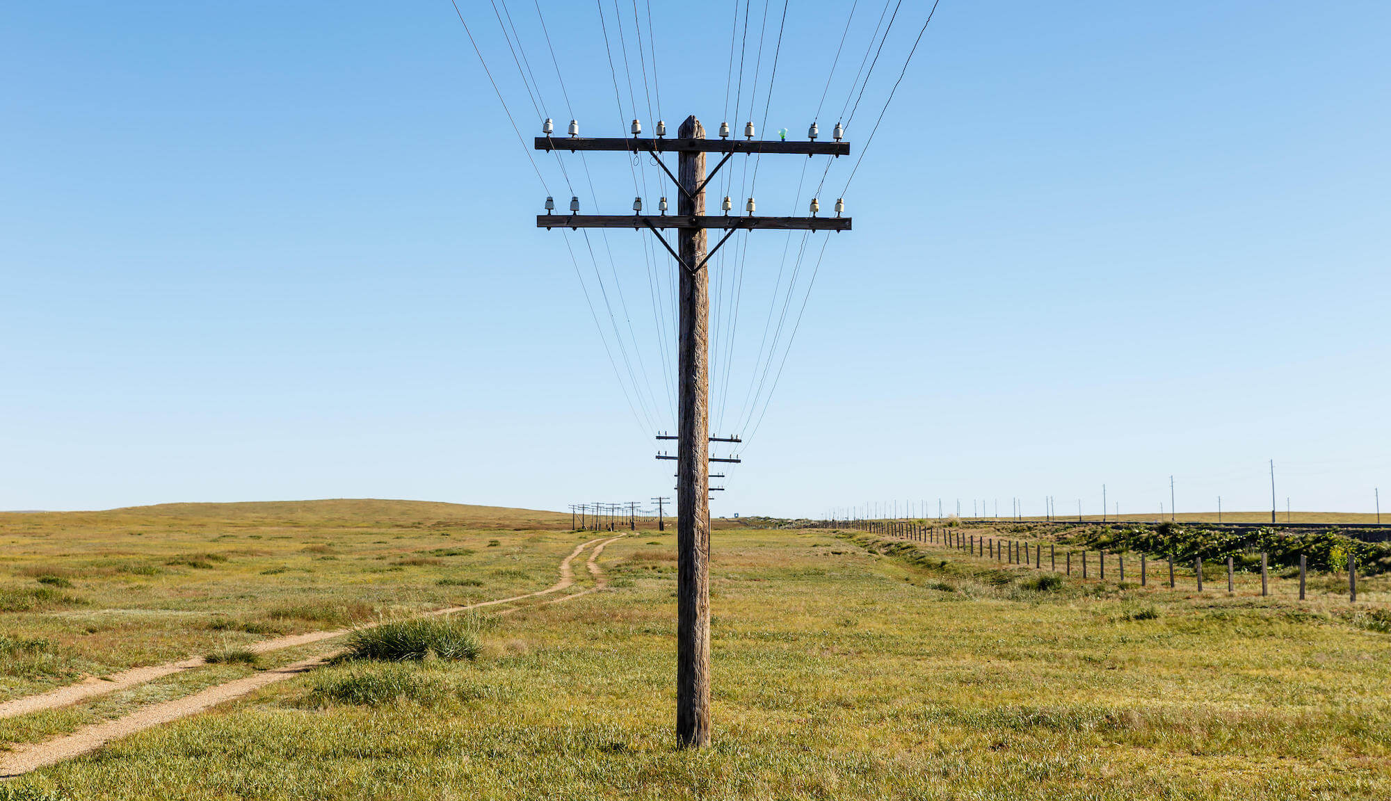 Utility Pole Materials: Which Is Best? - Hero Image of utility pole stood up in a field