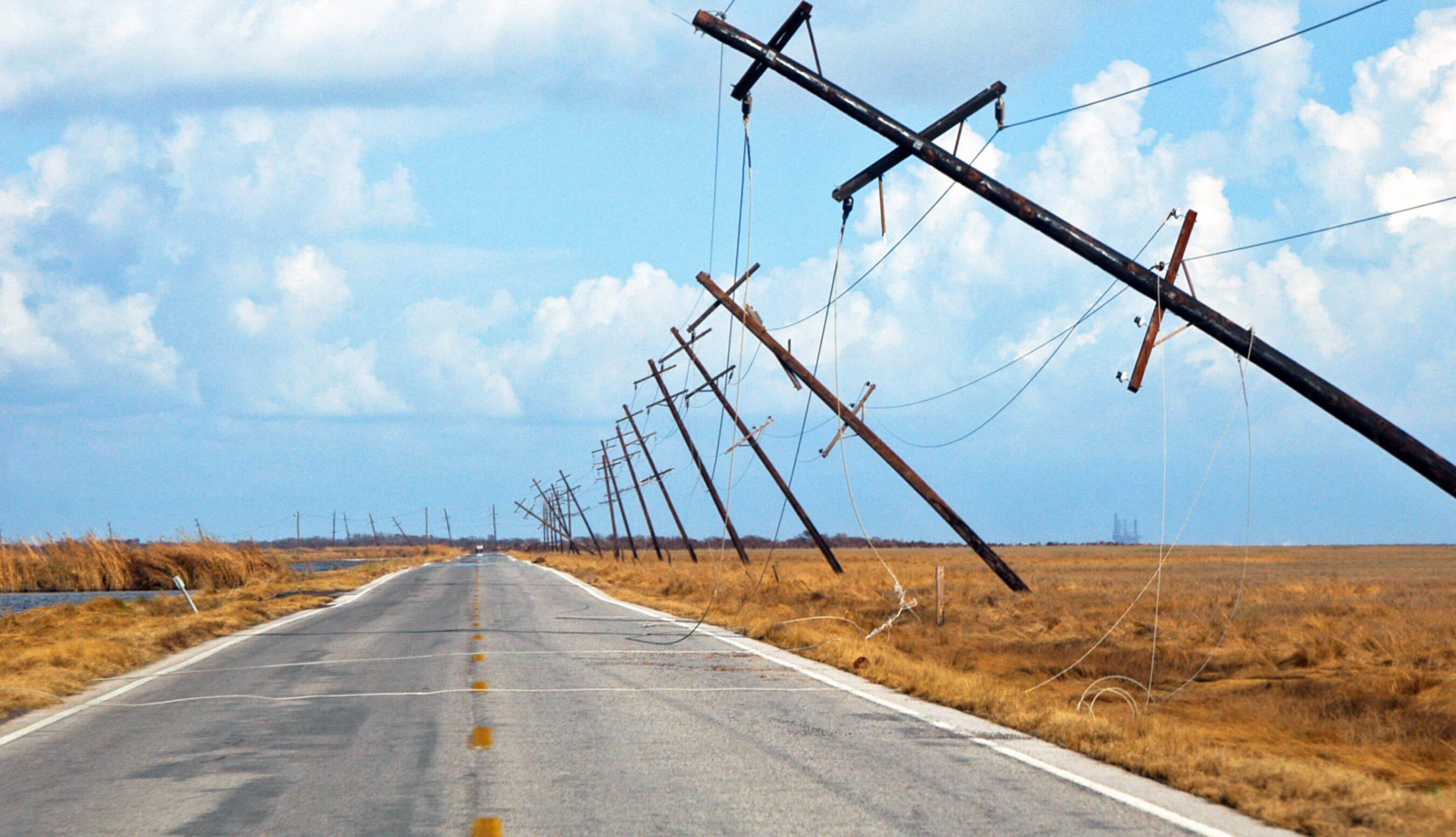 Row of wooden utility poles failed
