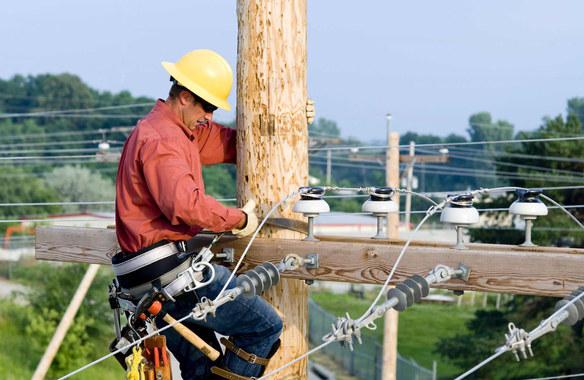 utility pole protection - Linesman working on wooden utility pole